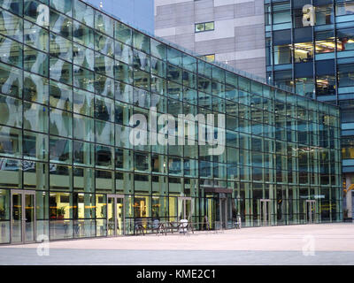 distorted reflections in curve of glazed facade of modern building at Media City Salford, Manchester, UK Stock Photo