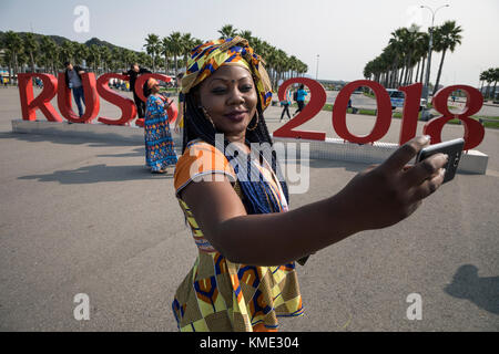 A girl from Cameroon makes a selfie on the background of the inscription 'Russia 2018' in the Olympic Park of Sochi, Krasnodar krai, Russia Stock Photo