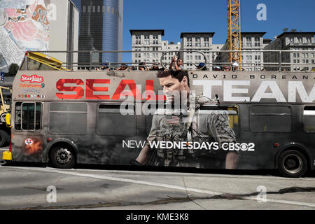 CBS SEAL TEAM advert with actor David Boreanaz on the side of an open top Star Line tourist bus in downtown Los Angeles, California USA  KATHY DEWITT Stock Photo