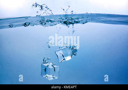 Ice Cubes Splashing in Clear Water Stock Photo