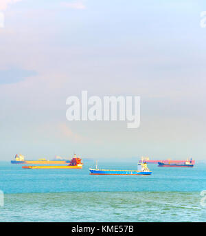 Industrial shipping tankers in Singapore harbor in the daytime Stock Photo