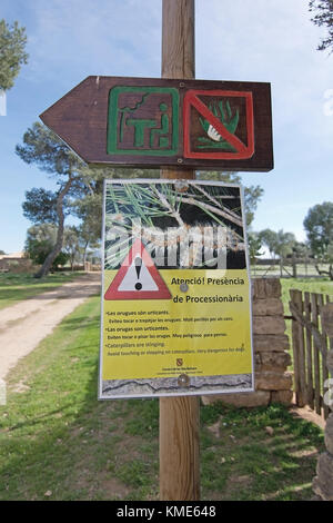 MALLORCA, BALEARIC ISLANDS, SPAIN - MARCH 6, 2017: Warning sign for dogs regarding processionary moth larvae on March 6, 2017 in Mallorca, Balearic is Stock Photo