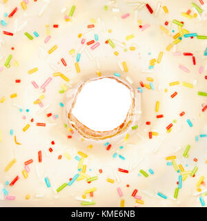 Overfill white chocolate doughnut close-up with rainbow sprinkles on white background Stock Photo