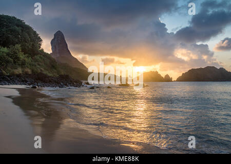 Sunset at Praia do Cachorro Beach with Morro do Pico on background - Fernando de Noronha, Pernambuco, Brazil Stock Photo