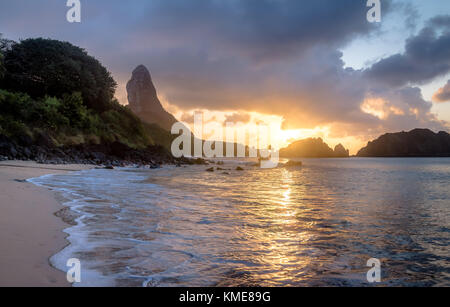 Sunset at Praia do Cachorro Beach with Morro do Pico on background - Fernando de Noronha, Pernambuco, Brazil Stock Photo