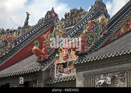 Roofing art detail, The Chen Clan Ancestral Hall in Guangzhou, China. Built by the 72 Chen clans for their juniors' accommodation and preparation for the imperial examinations in 1894 in Qing Dynasty, it now houses the Guangdong Folk Art Museum and is a symmetric complex consist of 19 buildings with nine halls and six courtyards.  A large collection of southern China art pieces stud all portions of the building.  It was added in the list of Cultural Relics of National Importance under the Protection of the State in 1988. Stock Photo