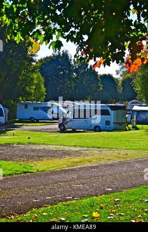 Motorhomes at Cirencester Park Caravan & Motorhome Club site in Autumn. Stock Photo