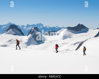 Three mountaineers are walking on Vallee Blanche, huge glacier in the Mont Blanc range on the border of France and Italy, Chamonix, Haute-Savoie, France Stock Photo