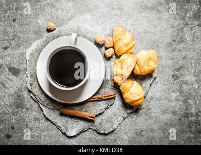 Fresh coffee and croissants. On the stone table. Stock Photo