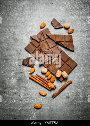 Chocolate with cinnamon and almonds. On the stone table. Stock Photo