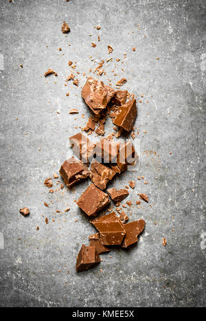 Pieces of dark chocolate. On the stone table. Stock Photo