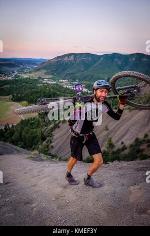 Male Mountain Biker in scenic landscape walks up Hogs back near Durango,Colorado,USA Stock Photo