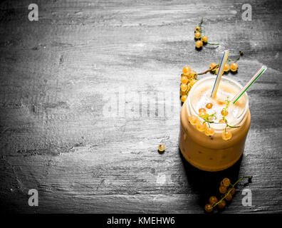 Smoothie made from white currants. On the black chalkboard Stock Photo