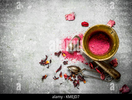 Ground pomegranate tea in a mortar. On the stone table. Stock Photo