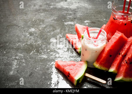 Watermelon smoothies and juice with pulp. On the stone table. Stock Photo