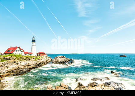 Cape Elizabeth, USA - June 10, 2017: Portland Head Lighthouse and museum building in Fort Williams park in Maine during summer day with cliff Stock Photo