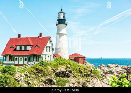 Cape Elizabeth, USA - June 10, 2017: Portland Head Lighthouse and museum building in Fort Williams park in Maine during summer day with cliff Stock Photo