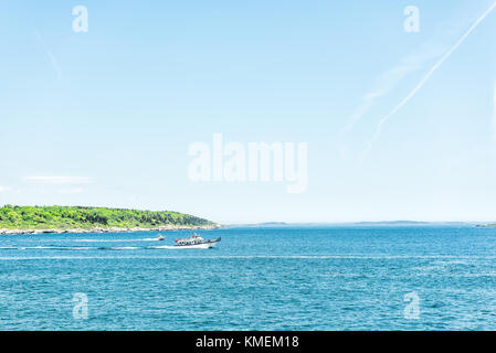 Cape Elizabeth, USA - June 10, 2017: Tour boat by Portland Head Lighthouse in Fort Williams park in Maine during summer day Stock Photo