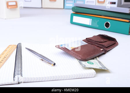 leather wallet with credit cards, Folder file, and note on the desk. blurred background. Stock Photo