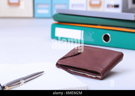 leather wallet with credit cards, Folder file, and note on the desk. blurred background. Stock Photo