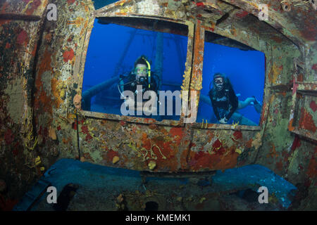 Divers peer through windows on bridge of USS Kittiwake