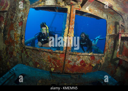 Divers peer through windows on bridge of USS Kittiwake