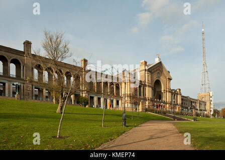 Alexandra Palace with iconic TV mast/ antenna, and architecture in sunshine, blue skies, light cloud. Haringey, North London, UK. Stock Photo