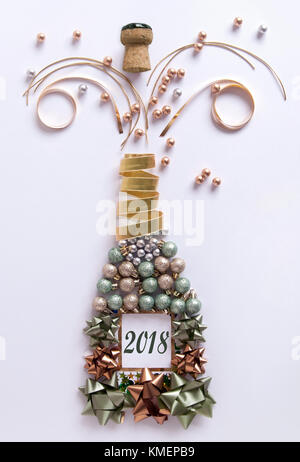 Open champagne bottle made from decorations including baubles and ribbon Stock Photo