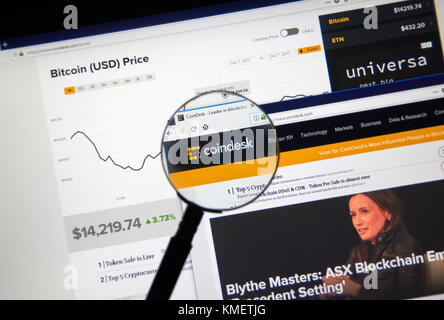 MONTREAL, CANADA - DECEMBER 7, 2017: Coindesk home webpage and logo under magnifying glass. CoinDesk is a news site specializing in bitcoin and digita Stock Photo