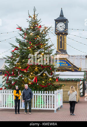 Christmas tree lit up at the entrance to Brighton Pier in Brighton, East Sussex, England, UK, in December 2017. Xmas tree with lights. Stock Photo