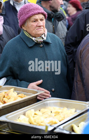 CRACOW, POLAND - DECEMBER 20, 2015:  Christmas Eve for poor and homeless on the Central Market in Cracow. Every year the group Kosciuszko prepares the Stock Photo