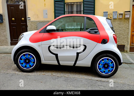 smart car parked on city street outside house, florence, italy Stock Photo