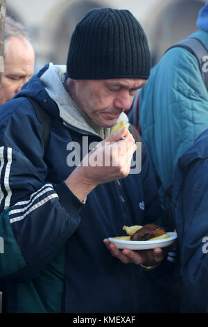 CRACOW, POLAND - DECEMBER 20, 2015:  Christmas Eve for poor and homeless on the Central Market in Cracow. Every year the group Kosciuszko prepares the Stock Photo