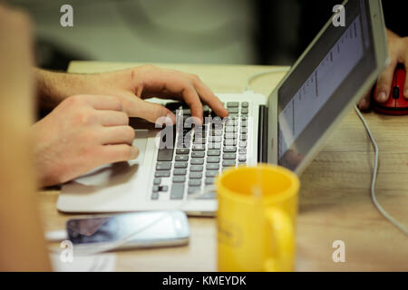 Man uses laptop for coding software Stock Photo
