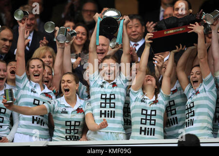 Cambridge women's captain Lara Gibson lifts the winners cup after the
