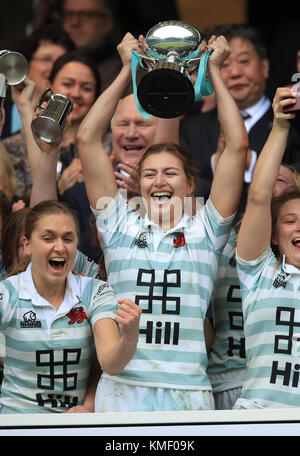 Cambridge women's captain Lara Gibson (right) lifts the winners cup