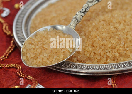 Brown sugar on spoon and plate Stock Photo