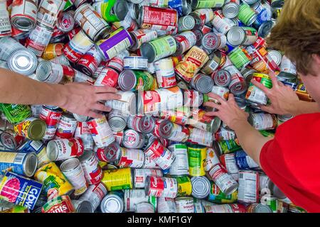Volunteers from a Chicago high school church group separate canned food during the U.S. Department of Agriculture Feds Feed Families National Kick-Off Event at the Capital Area Food Bank June 7, 2017 in Washington, DC.  (photo by Preston Keres  via Planetpix) Stock Photo