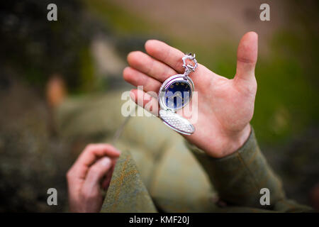 Man in suit looking at his pocket watch. The concept of expectations. Stock Photo