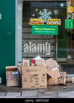 Merry Feastmas at Subway in Preston with cardboard food boxes awaiting street collection, UK Stock Photo