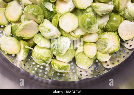 Brussel Sprouts in a steaming rack inside of a pot for cooking Stock Photo
