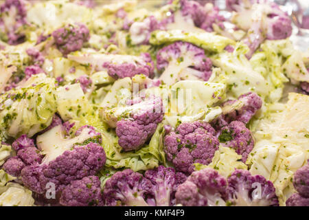 Colorful raw purple cauliflower and green cabbage ready for oven roasting Stock Photo