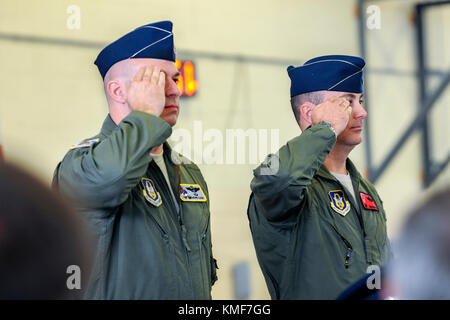 Lt. Col. Gerald Cook, left, outgoing commander of the 76th Fighter Squadron (FS) and Lt. Col. Brandon Kelly, incoming 76th FS commander, render salutes during an Assumption of Command ceremony, Dec. 3, 2017, at Moody Air Force Base, Ga. An Assumption of Command is a military tradition that represents a formal assumption of a unit’s authority and responsibility by a commander. Stock Photo