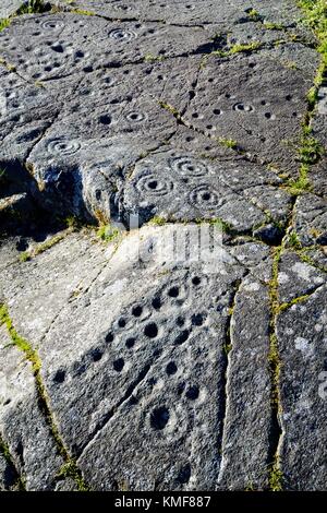 Cup and ring mark marks prehistoric Neolithic rock art on natural rock ...