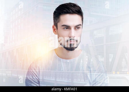 Young handsome teacher looking strict while being at work Stock Photo