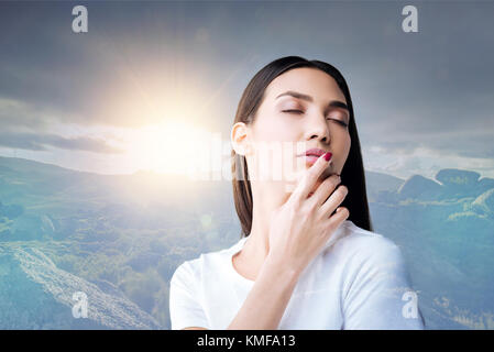 Romantic emotional woman remembering her boyfriend while closing her eyes Stock Photo