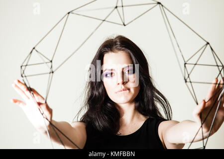 Female holding model of geometric solid Stock Photo