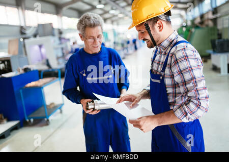 Team Of Engineers Having Discussion In Factory Stock Photo