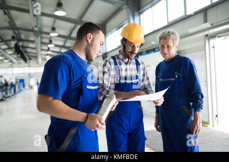 Supplier with engineer checking on production in factory Stock Photo