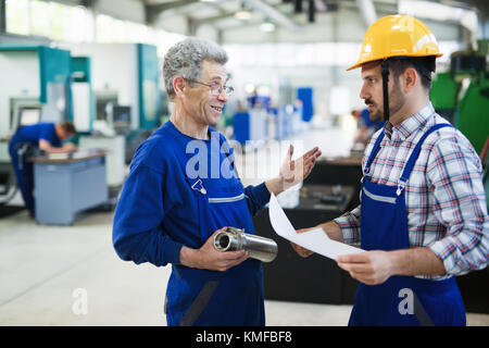 Team Of Engineers Having Discussion In Factory Stock Photo